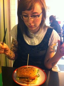Photo of zinester for Tale of the Gray Wolf with fork and knife in hand, about to dig into a burger.